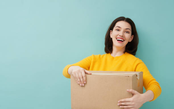 istock woman is holding cardboard box 1218377414
