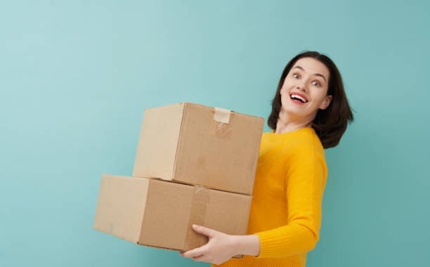 istock woman is holding cardboard box 1218377415