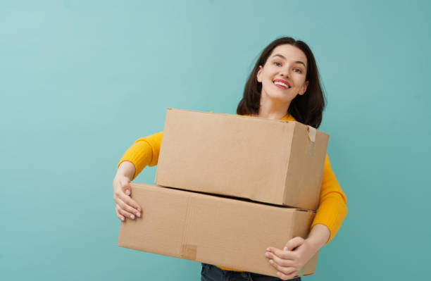 istock woman is holding cardboard box 1218377432