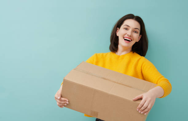 istock woman is holding cardboard box 1218377435