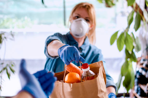 istock Volunteer Bringing food to old and disability people in quarantine 1218379207