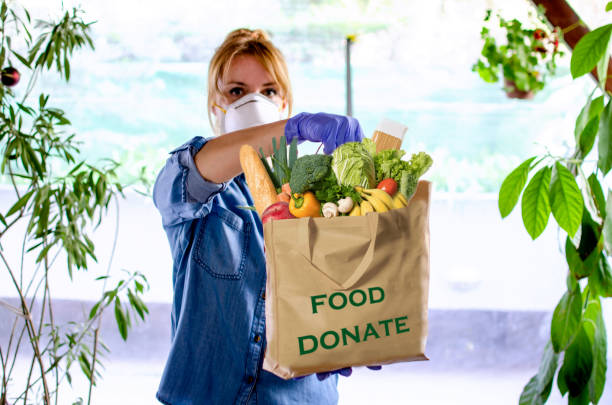istock Volunteer Bringing food to old and disability people in quarantine 1218379211