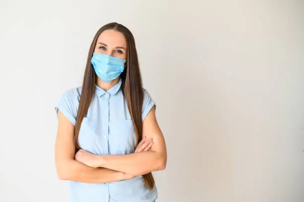 Photo of Positive young woman in medical mask