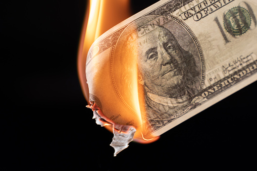 Dollar bill USA money burning in flames, economic crisis or inflation concept.