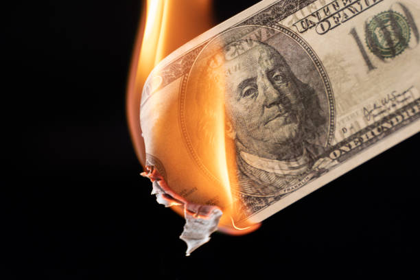 Dollar bill USA money burning in flames, economic crisis or inflation concept stock photo