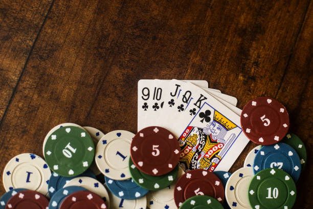 Royal Flush Gambling chips and Royal Flush on wooden background. texas hold em photos stock pictures, royalty-free photos & images