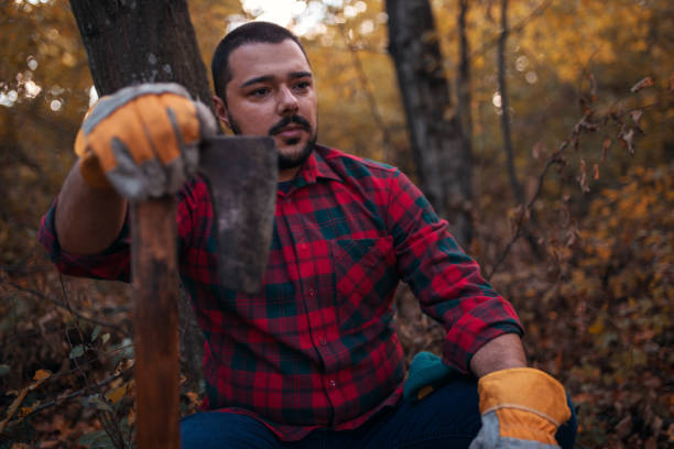 istock Portrait of young lumberjack holding axe 1218385075