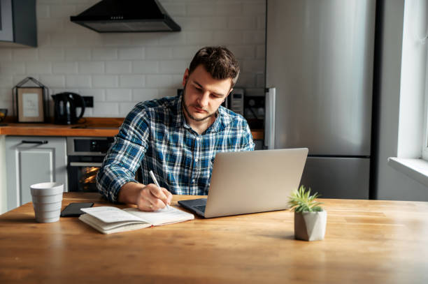 istock Young male freelancer works from home 1218385369