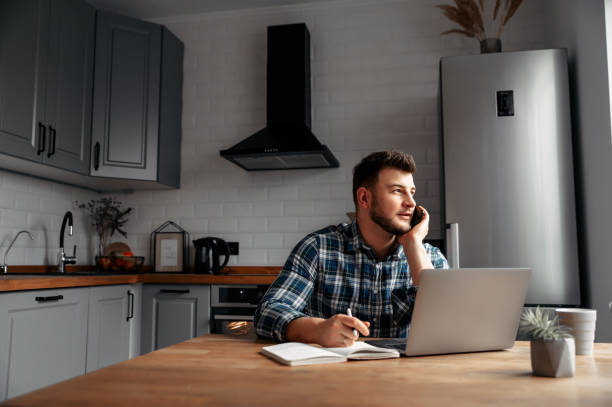 istock Young male freelancer works from home 1218385393