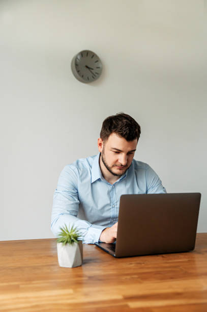 istock Attractive male office worker is using a laptop 1218385942