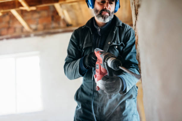 istock male worker using pneumatic hammer drill to cut the wall concrete brick 1218386307