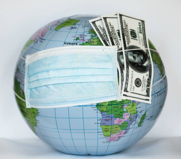 istock Globe with money covered with respiratory mask - Covid 19 1218389705