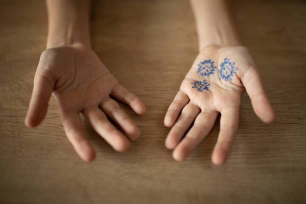 istock Boy at home with virus drawing on his hands 1218390499