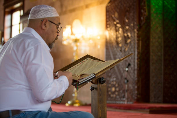 istock Muslim man reading Koran in mosque 1218391859