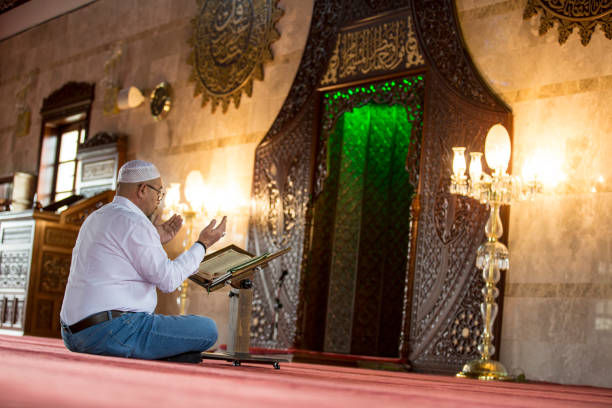 istock Muslim man reading Koran in mosque 1218392602