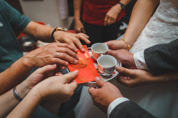 istock Chinese wedding tea ceremony with people hands serving tea to elders. 1218392821