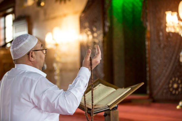 istock Muslim man reading Koran in mosque 1218393254