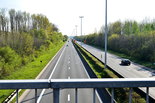 Saturday April 11, 2020 : walking, bicycling activities in your region allowed during lock down. Poor vehicle traffic on the highway road seen from bridge in Kessel-lo, Leuven direction Limburg.