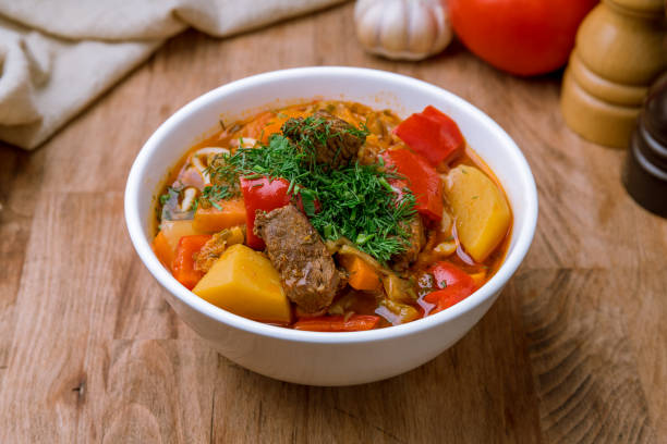 istock Lagman asian soup on white plate on wooden table 1218398314