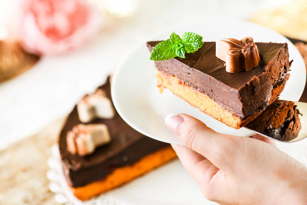 istock Delicious caramel chocolate tart with mint leaf on top. 1218398846