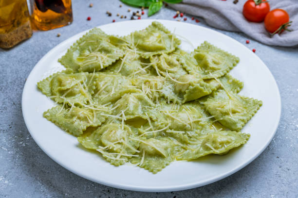 istock Green ravioli with spinach on white plate 1218399489