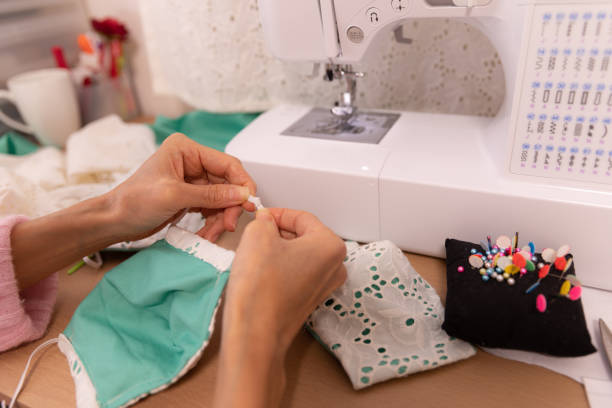istock Japanese woman making mask at home 1218399587