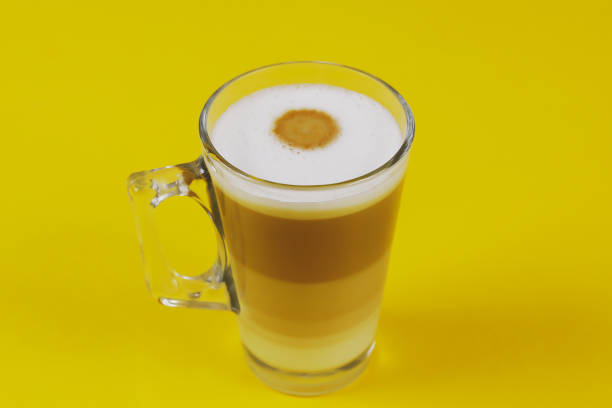 istock cup of cappuccino on a yellow background 1218401288