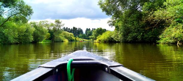 Canoeing through a river. boat ride. old canoe on river Lahn in germany. Active, adventure, outdoors, canoeing, kayaking