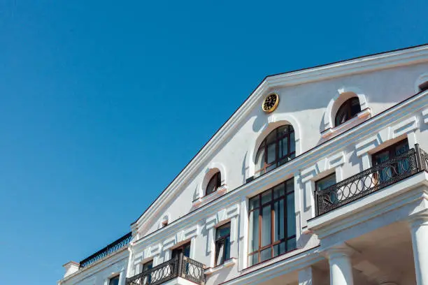 Photo of house with a clock roof against the blue sky