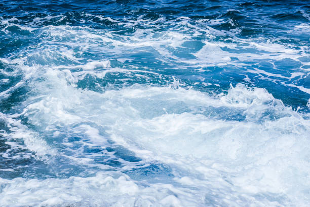 istock Waves crashing on rocks in blue ocean. 1218407308