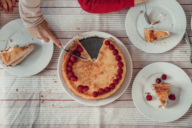 Mother serving cheesecake to children