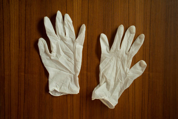 istock Latex gloves on wood texture 1218409762