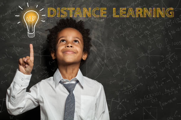 istock Black child boy with light bulb, science formulas. Distance learning concept 1218410810