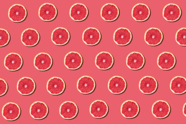 istock Fresh red orange or grapefruit on a peach color background. 1218411358