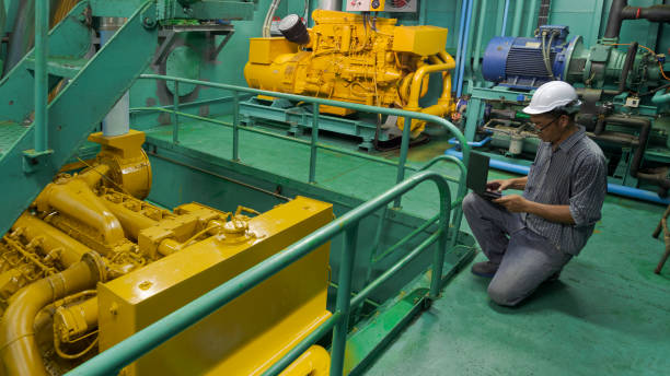 asian engineer working in engine room. he using laptop in engine inspection of fishing vessel - vessel part imagens e fotografias de stock