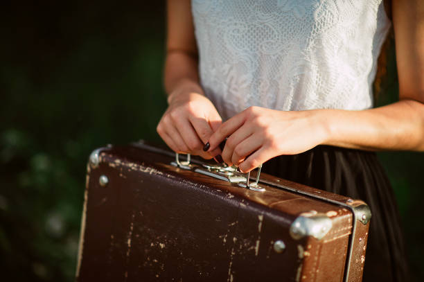 Beautiful girl beautiful girl holds a cup of tea in nature at sunset, holds a mirror, a suitcase. child casket stock pictures, royalty-free photos & images