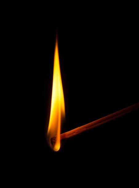 istock Closeup of burning match, isolated. Fire flame. 1218414736