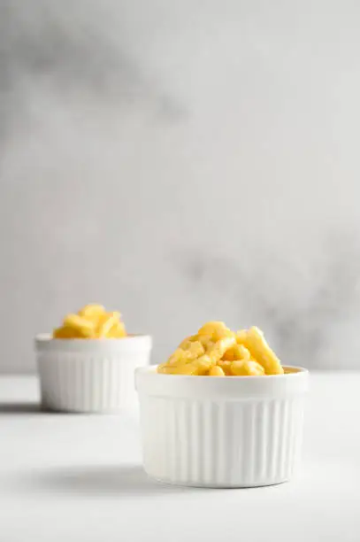 Photo of Two ramekin with chak chak on a white table.