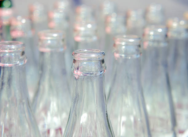 Many used glass bottles arranged in rows. Close up and selective focus of empty soda bottles, Recyclable object image.