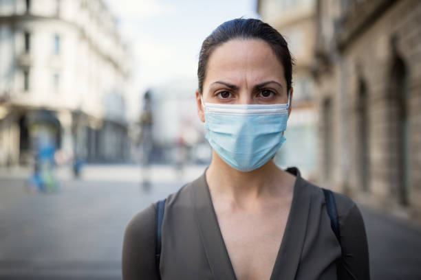 istock Woman wearing protective mask 1218419600