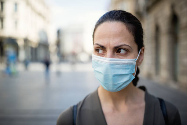 istock Woman wearing protective mask 1218419751
