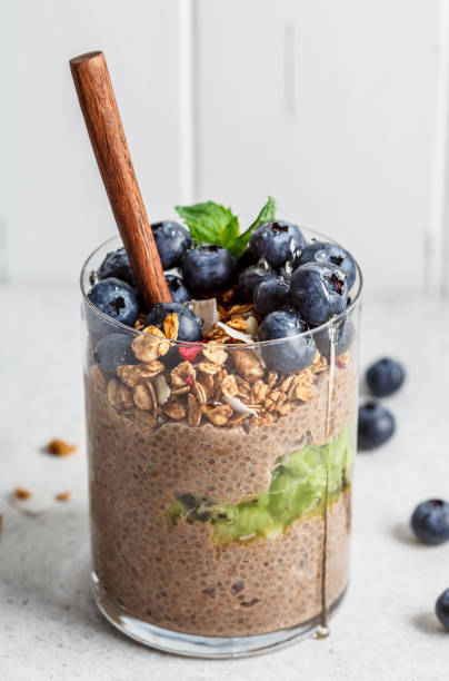 istock Chocolate chia pudding with fruits, granola and berries in glass. 1218420965