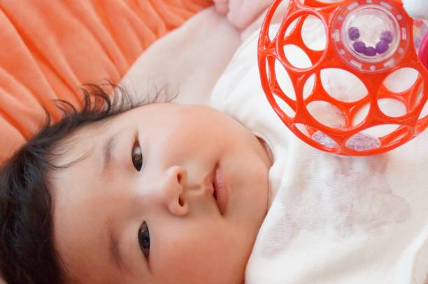 istock baby playing with O'ball 1218422960