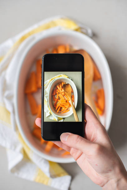 istock Cooking sliced orange sweet potatoes in a ceramic baking dish 1218425253
