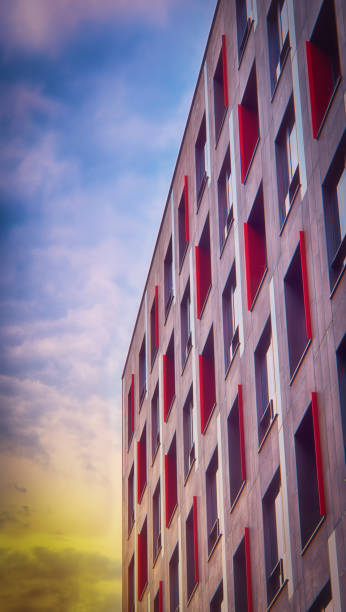 Side view of a beautiful colorful building with contemporary architectural design and orange sunny sky.