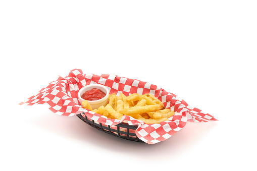 Freshly cooked french fries or chips in a basket photographed on a white background with ample copy space.