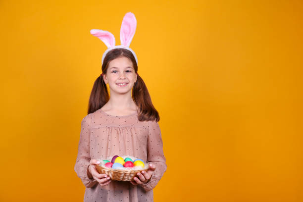 istock Conceptual image with a girl wearing bunny ears for easter celebration. 1218429485