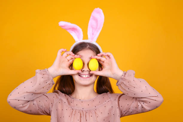 istock Conceptual image with a girl wearing bunny ears for easter celebration. 1218429490