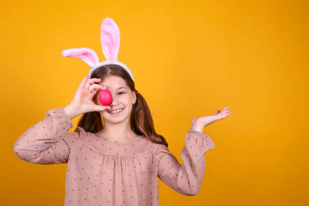 istock Conceptual image with a girl wearing bunny ears for easter celebration. 1218430059
