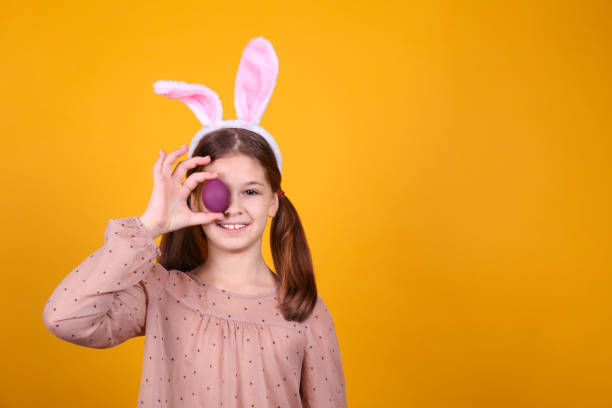 istock Conceptual image with a girl wearing bunny ears for easter celebration. 1218430090